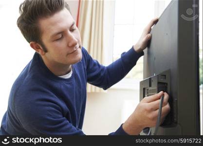 Television Engineer Installing New TV At Home