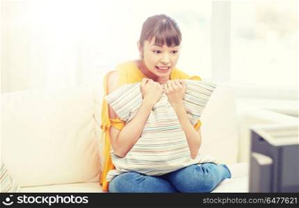 television, leisure and people concept - asian young woman watching tv at home. asian young woman watching tv at home. asian young woman watching tv at home