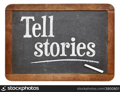 Tell stories advice - text in white chalk on a vintage slate blackboard