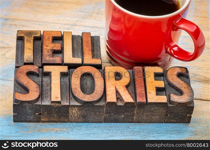 tell stories word abstract - text in vintage letterpress wood type with a cup of coffee - storytelling concept