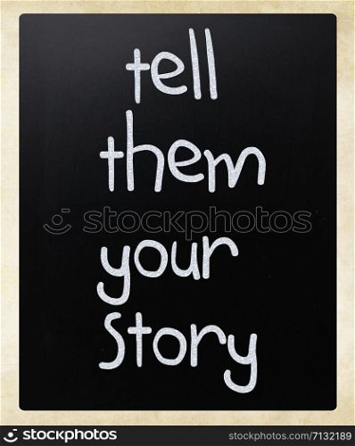 ""Tell them your story" handwritten with white chalk on a blackboard"