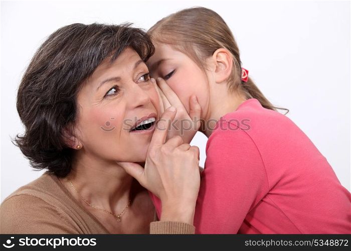 Telling her mother a secret.