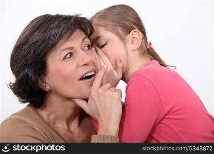 Telling her mother a secret.