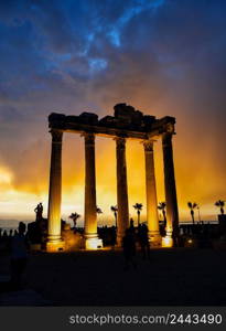 Temple of Apollo in Side at sunset. Silhouettes of people. Architectural heritage. A popular tourist destination. One of the main attractions of Turkey. Temple of Apollo in Side at sunset