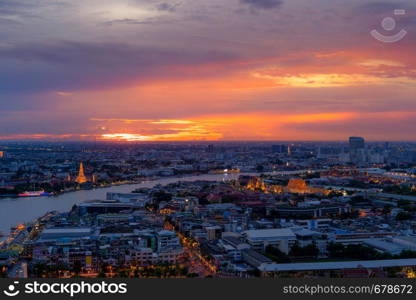 Temple of Dawn, Wat Pho Temple with buildings and curve of Chao Phraya River. Urban city, Downtown Bangkok at sunset, Thailand.