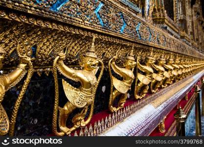 Temple of the Emerald Buddha. Gold ornamental patter statuettes.Wat Pra-keaw Bangkok,Thailand.