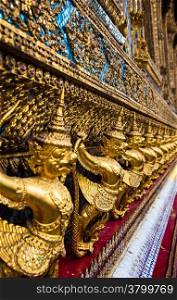 Temple of the Emerald Buddha. Gold ornamental patter statuettes.Wat Pra-keaw Bangkok,Thailand.