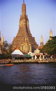 Temple on the bank of a river, Wat Arun, Bangkok, Thailand