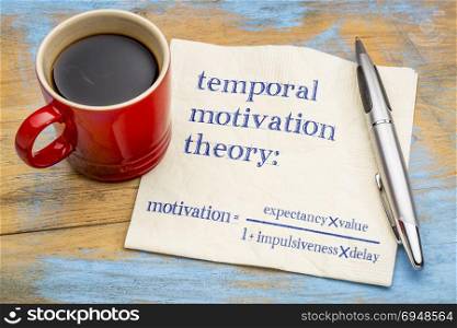 temporal motivation theory, equation - handwriting on a napkin with a cup of coffee