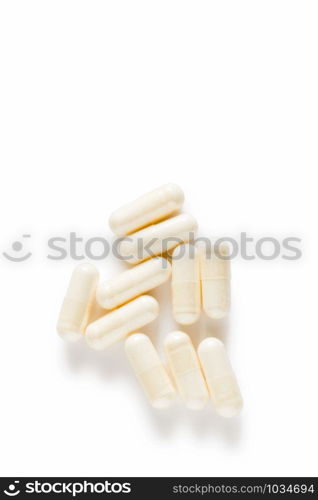 Ten yoghurt capsules isolated on a white background. Yoghurt Capsules aid in maintaining a normal healthy gastrointestinal system and digestive function.