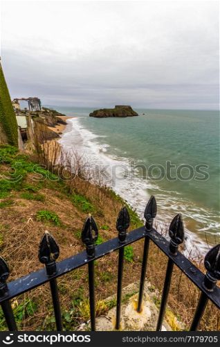 Tenby, castle Beach and St Catherines Island, in Pembrokeshire, Wales, from the west railings in foreground.