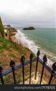 Tenby, castle Beach and St Catherines Island, in Pembrokeshire, Wales, from the west railings in foreground.