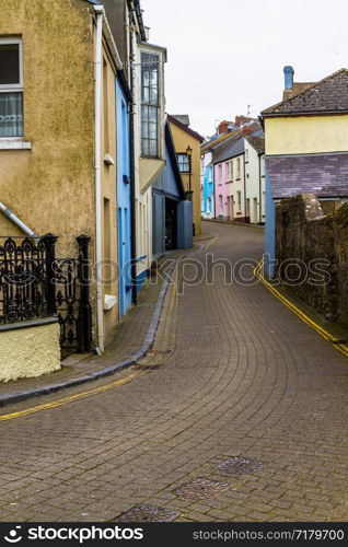 Tenby small street with houses of different colours. Wales, UK, portrait.