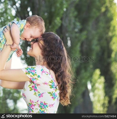 Tender mom tossing her baby child