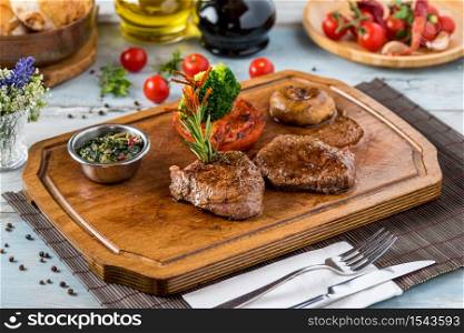 Tenderloin Steak Roast beef on wooden cutting board on wooden background
