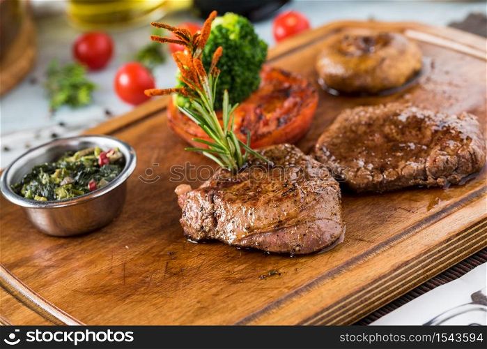 Tenderloin Steak Roast beef on wooden cutting board on wooden background