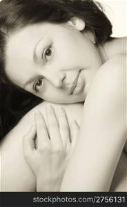 Tenderness.The beautiful young woman embracing hands. Natural beauty.Monochrome tone