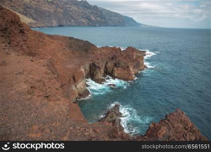 Tenerife island. On the cliff is a village at the bottom of the raging ocean