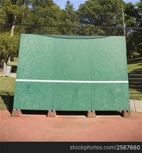 Tennis backboard for single practice in park.