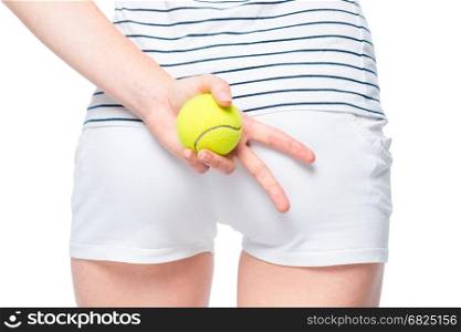 Tennis ball in the hand of an athlete close-up. At the hip level