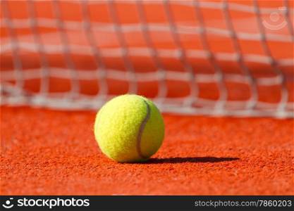 Tennis ball on a hard court