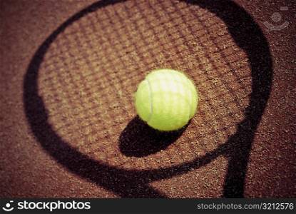 Tennis ball on shadow of a tennis racket