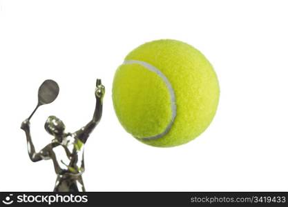 Tennis ball suspened with trophy behind on white background