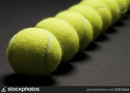 Tennis balls arranged in a row