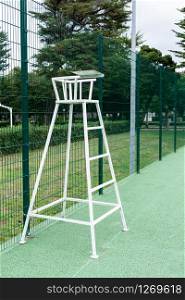 Tennis chair on outdoor court. No people