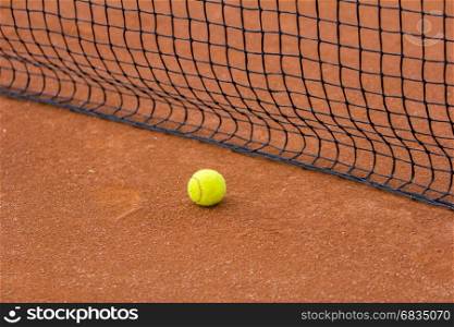 Tennis court with tennis ball and net