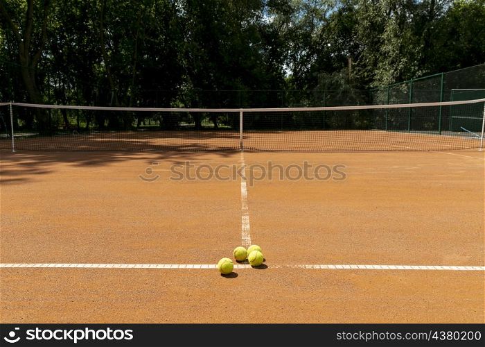 tennis court with tennis balls ground