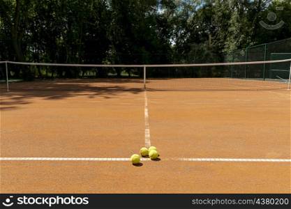 tennis court with tennis balls ground