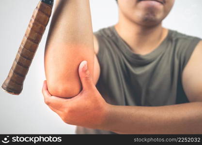 Tennis elbow injury concept. The man holds racket. Symptom area is shown with red color. Healthcare knowledge. Medium close up shot.