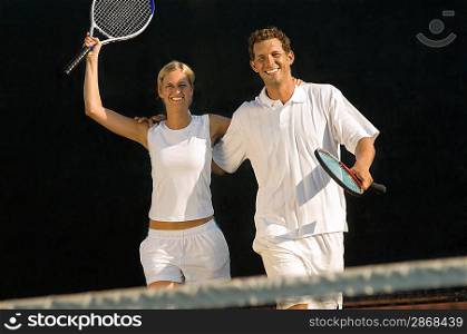 Tennis Partners Raising Rackets in Victory