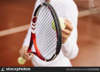 tennis player holding tennis equipment
