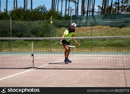 Tennis player performing a drop shot on court.