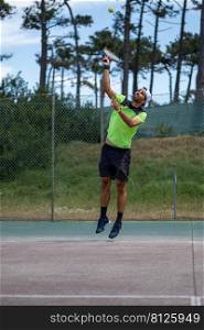 Tennis player performing a service on court.
