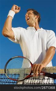 Tennis Player Pumping His Fist at Net