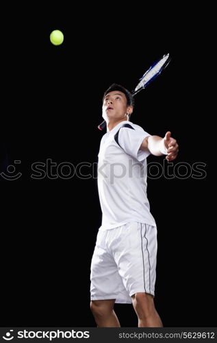 Tennis player ready to hit ball, portrait