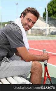 Tennis player sitting on the bench