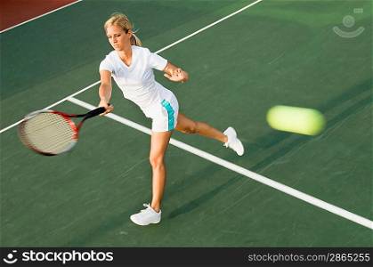 Tennis Player Swinging at Ball