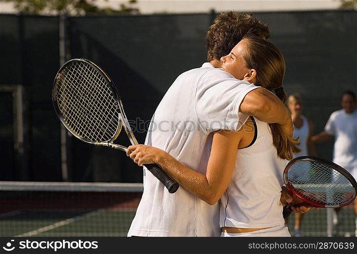 Tennis Players Hugging at Net