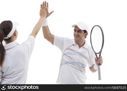 Tennis players making high five isolated over white background