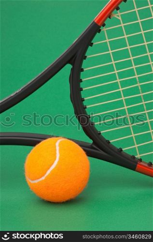 tennis racket and ball on a green background