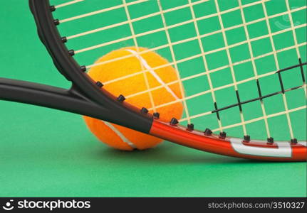 tennis racket and ball on a green background