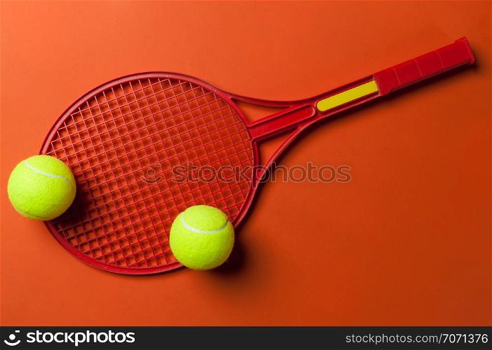 tennis racket and ball on red background