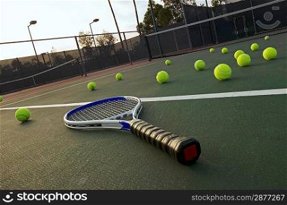 Tennis Racket and Balls on Court