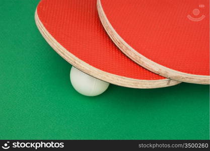 tennis racquets on a green table