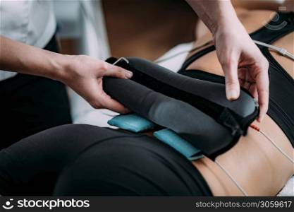 TENS, Transcutaneous Electrical Nerve Stimulation in Physical Therapy. Therapist Positioning Electrodes onto Patient?s Lower Back