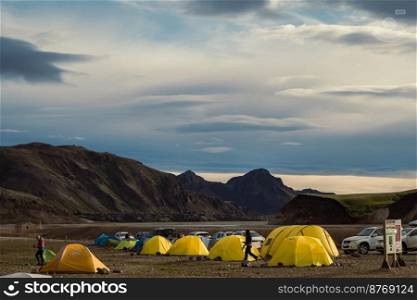 Tent camping landscape photo. Beautiful nature scenery photography with large mountains on background. Idyllic scene. High quality picture for wallpaper, travel blog, magazine, article. Tent camping landscape photo